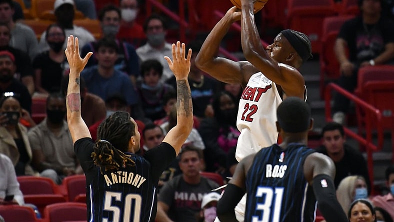 Oct 25, 2021; Miami, Florida, USA; Miami Heat forward Jimmy Butler (22) shoots the ball over Orlando Magic guards Cole Anthony (50) and Terrence Ross (31) during the first half at FTX Arena. Mandatory Credit: Jim Rassol-USA TODAY Sports