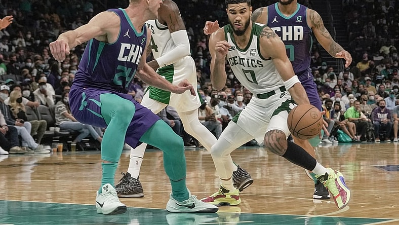Oct 25, 2021; Charlotte, North Carolina, USA; Boston Celtics forward Jayson Tatum (0) drives to the basket against Charlotte Hornets center Mason Plumlee (24) during overtime at the Spectrum Center. Mandatory Credit: Jim Dedmon-USA TODAY Sports