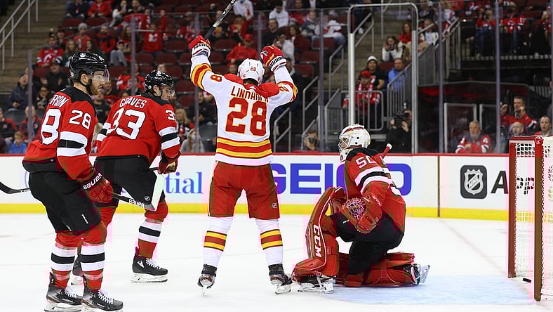 Oct 26, 2021; Newark, New Jersey, USA; Calgary Flames center Elias Lindholm (28) celebrates his goal on New Jersey Devils goaltender Nico Daws (50) during the first period at Prudential Center. Mandatory Credit: Ed Mulholland-USA TODAY Sports