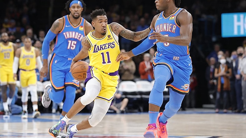 Oct 27, 2021; Oklahoma City, Oklahoma, USA; Los Angeles Lakers guard Malik Monk (11) drives down the court as Oklahoma City Thunder forward Luguentz Dort (5) defends during the first quarter at Paycom Center. Mandatory Credit: Alonzo Adams-USA TODAY Sports