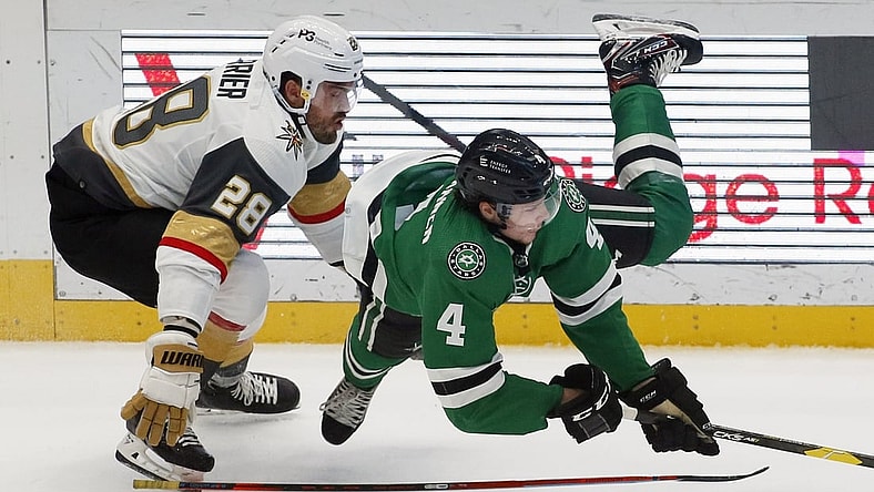 Oct 27, 2021; Dallas, Texas, USA; Dallas Stars defenseman Miro Heiskanen (4) picks up the tripping penalty on Vegas Golden Knights left wing William Carrier (28) during the first period at American Airlines Center. Mandatory Credit: Raymond Carlin III-USA TODAY Sports