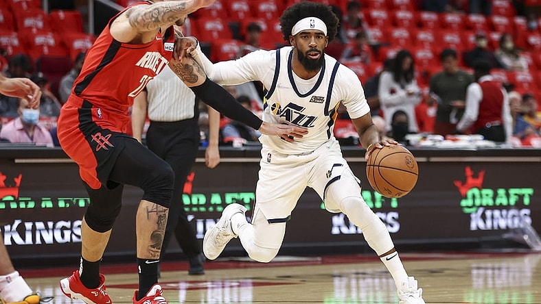 Oct 28, 2021; Houston, Texas, USA; Utah Jazz guard Mike Conley (11) dribbles the ball as Houston Rockets center Daniel Theis (27) defends during the first quarter at Toyota Center. Mandatory Credit: Troy Taormina-USA TODAY Sports