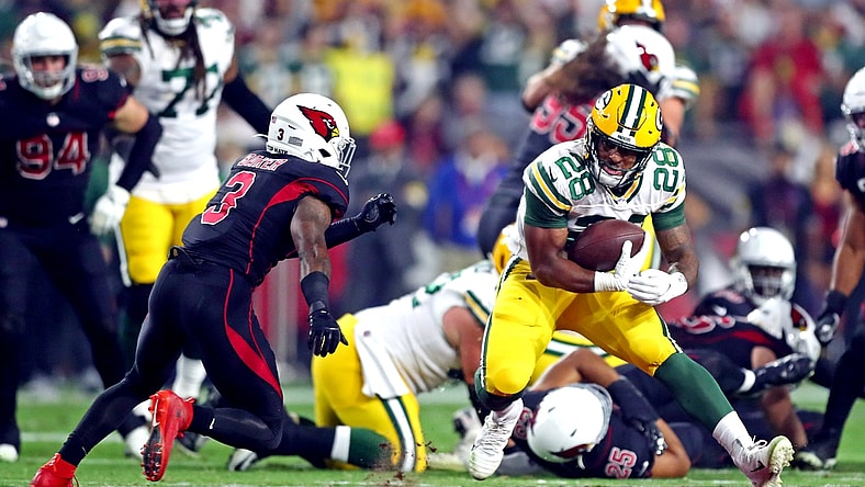 Oct 28, 2021; Glendale, Arizona, USA; Green Bay Packers running back A.J. Dillon (28) runs the ball against Arizona Cardinals safety Budda Baker (3) during the first half at State Farm Stadium. Mandatory Credit: Mark J. Rebilas-USA TODAY Sports