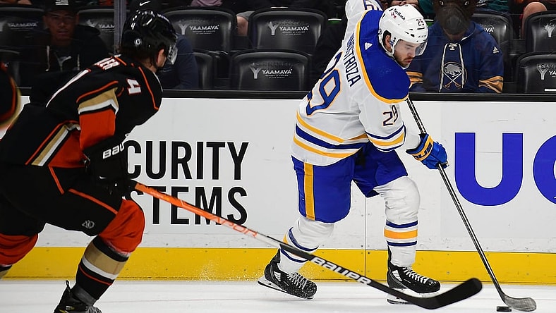 Oct 28, 2021; Anaheim, California, USA; Buffalo Sabres left wing Vinnie Hinostroza (29) moves the puck ahead of Anaheim Ducks defenseman Cam Fowler (4) during the first period at Honda Center. Mandatory Credit: Gary A. Vasquez-USA TODAY Sports