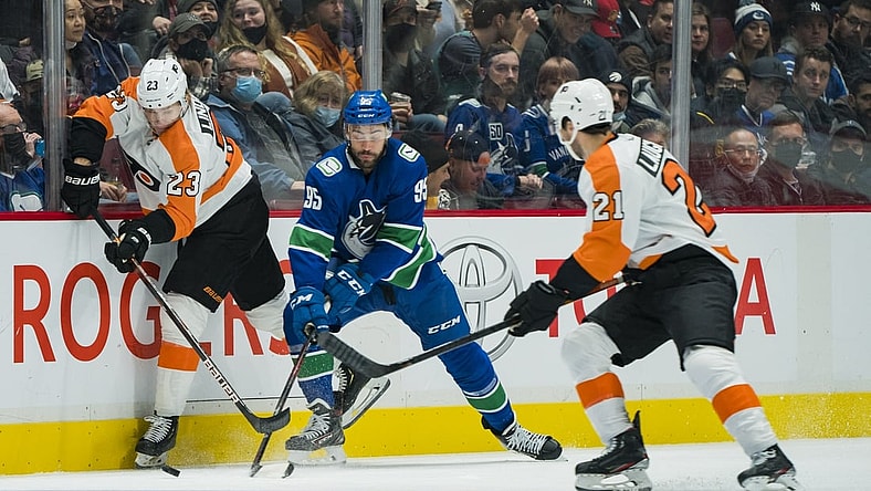 Oct 28, 2021; Vancouver, British Columbia, CAN; Philadelphia Flyers forward Oskar Lindblom (23) checks Vancouver Canucks forward Justin Bailey (95) in the first period at Rogers Arena. Mandatory Credit: Bob Frid-USA TODAY Sports