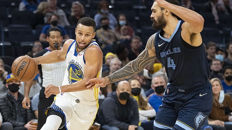 October 28, 2021; San Francisco, California, USA; Golden State Warriors guard Stephen Curry (30) dribbles the basketball against Memphis Grizzlies center Steven Adams (4) during the second quarter at Chase Center. Mandatory Credit: Kyle Terada-USA TODAY Sports