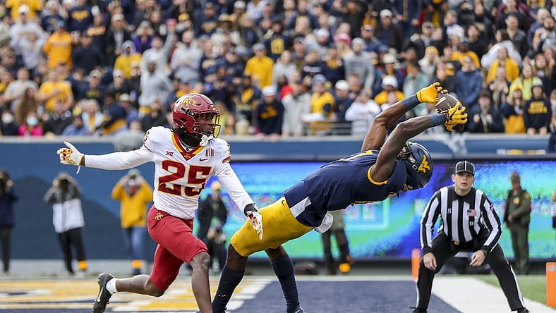 Oct 30, 2021; Morgantown, West Virginia, USA; West Virginia Mountaineers wide receiver Bryce Ford-Wheaton (0) catches a pass for a touchdown during the third quarter against the Iowa State Cyclones at Mountaineer Field at Milan Puskar Stadium. Mandatory Credit: Ben Queen-USA TODAY Sports