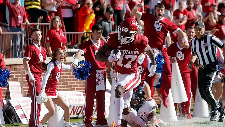 Oklahoma's Marvin Mims (17) scores a touchdown in front of Texas Tech's Malik Dunlap (8) during a college football game between the University of Oklahoma Sooners (OU) and the Texas Tech Red Raiders at Gaylord Family-Oklahoma Memorial Stadium in Norman, Okla., Saturday, Oct. 30, 2021.

Ou Vc Texas Tech