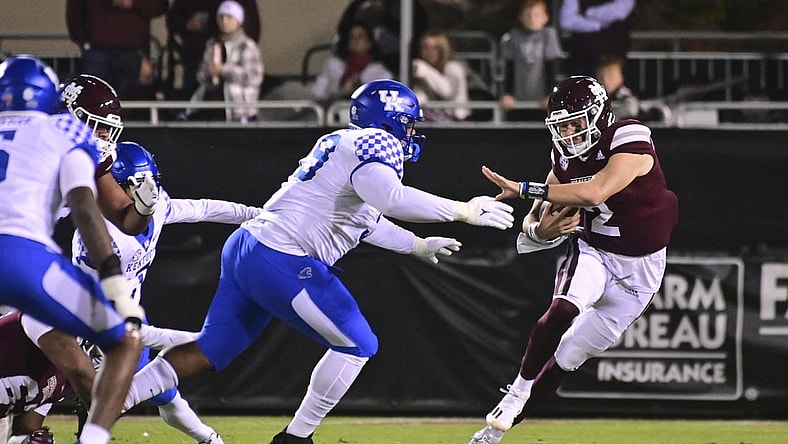Oct 30, 2021; Starkville, Mississippi, USA; Mississippi State Bulldogs quarterback Will Rogers (2) runs the ball while defended by Kentucky Wildcats defensive lineman Josaih Hayes (99) during the first quarter at Davis Wade Stadium at Scott Field. Mandatory Credit: Matt Bush-USA TODAY Sports