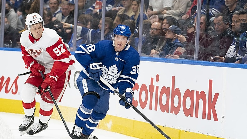 Oct 30, 2021; Toronto, Ontario, CAN; Toronto Maple Leafs defenseman Rasmus Sandin (38) controls the puck as Detroit Red Wings center Vladislav Namestnikov (92) gives chase during the first period at Scotiabank Arena. Mandatory Credit: Nick Turchiaro-USA TODAY Sports