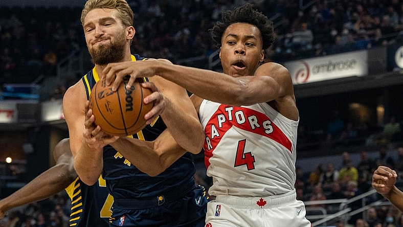 Oct 30, 2021; Indianapolis, Indiana, USA; Indiana Pacers forward Domantas Sabonis (11) and Toronto Raptors forward Scottie Barnes (4) fight for a rebound in the first half at Gainbridge Fieldhouse. Mandatory Credit: Trevor Ruszkowski-USA TODAY Sports