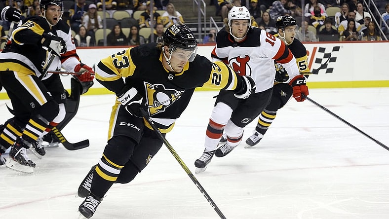 Oct 30, 2021; Pittsburgh, Pennsylvania, USA;  Pittsburgh Penguins left wing Brock McGinn (23) skates with the puck against the New Jersey Devils during the first period at PPG Paints Arena. Mandatory Credit: Charles LeClaire-USA TODAY Sports