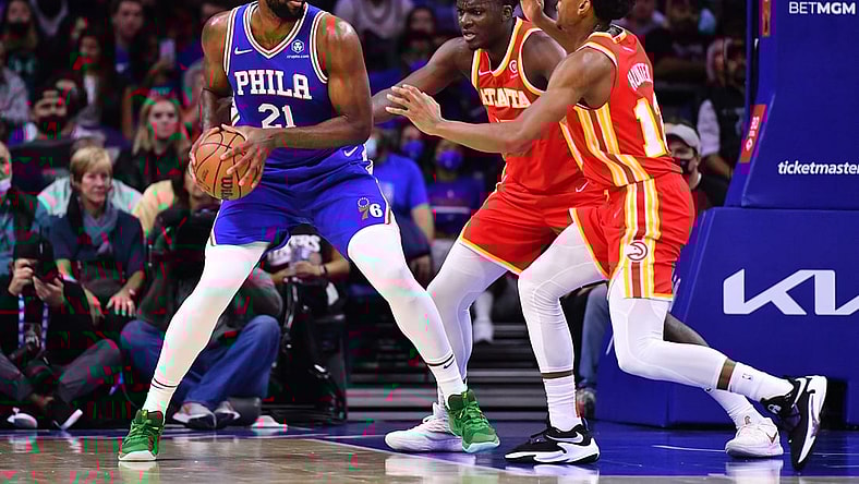 Oct 30, 2021; Philadelphia, Pennsylvania, USA; Philadelphia 76ers center Joel Embiid (21) controls the ball against Atlanta Hawks center Clint Capela (15) and forward De'Andre Hunter (12) in the first quarter at Wells Fargo Center. Mandatory Credit: Kyle Ross-USA TODAY Sports