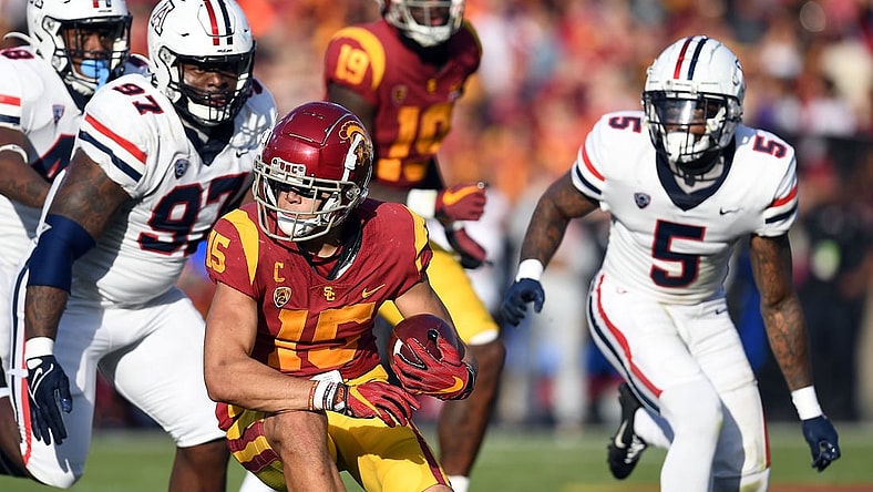 Oct 30, 2021; Los Angeles, California, USA; Southern California Trojans wide receiver Drake London (15) runs the ball ahead of Arizona Wildcats defensive lineman Leevel Tatum III (97) and linebacker Christian Young (5) during the first half at United Airlines Field at Los Angeles Memorial Coliseum. Mandatory Credit: Gary A. Vasquez-USA TODAY Sports