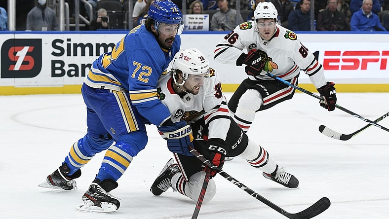 Oct 30, 2021; St. Louis, Missouri, USA; Chicago Blackhawks left wing Brandon Hagel (38) battles St. Louis Blues defenseman Justin Faulk (72) during the first period at Enterprise Center. Mandatory Credit: Jeff Le-USA TODAY Sports