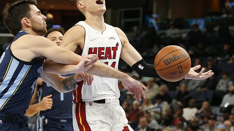 Oct 30, 2021; Memphis, Tennessee, USA; Miami Heat guard Tyler Herro (14) is fouled by Memphis Grizzlies guard John Konchar (46) in the second quarter at FedExForum. Mandatory Credit: Tim Heitman-USA TODAY Sports