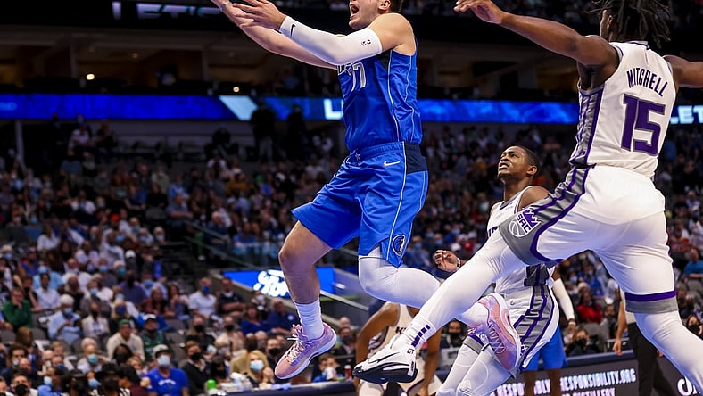 Oct 31, 2021; Dallas, Texas, USA;  Dallas Mavericks guard Luka Doncic (77) shoots past Sacramento Kings guard Davion Mitchell (15) during the first half at American Airlines Center. Mandatory Credit: Kevin Jairaj-USA TODAY Sports