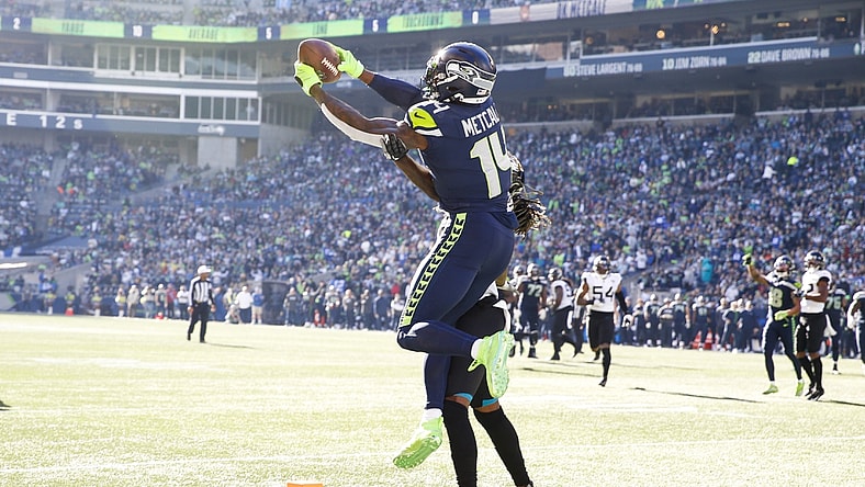 Oct 31, 2021; Seattle, Washington, USA; Seattle Seahawks wide receiver DK Metcalf (14) catches a touchdown pass against Jacksonville Jaguars cornerback Shaquill Griffin (26) during the second quarter at Lumen Field. Mandatory Credit: Joe Nicholson-USA TODAY Sports