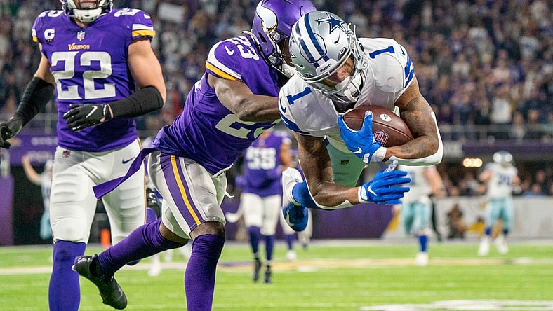 Oct 31, 2021; Minneapolis, Minnesota, USA; Dallas Cowboys wide receiver Ced Wilson (1) scores a touchdown in the third quarter as Minnesota Vikings free safety Xavier Woods (23) and safety Harrison Smith (22) defend at U.S. Bank Stadium. Mandatory Credit: Matt Blewett-USA TODAY Sports