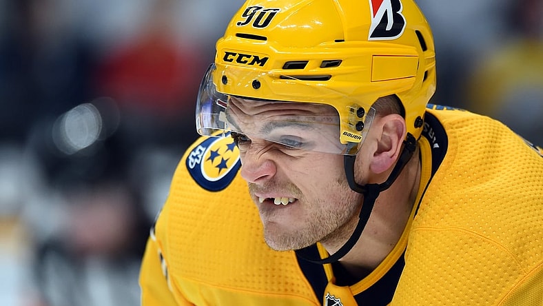 Feb 13, 2021; Nashville, Tennessee, USA; Nashville Predators defenseman Mark Borowiecki (90) lines up for a face off against the Detroit Red Wings during the second period at Bridgestone Arena. Mandatory Credit: Christopher Hanewinckel-USA TODAY Sports