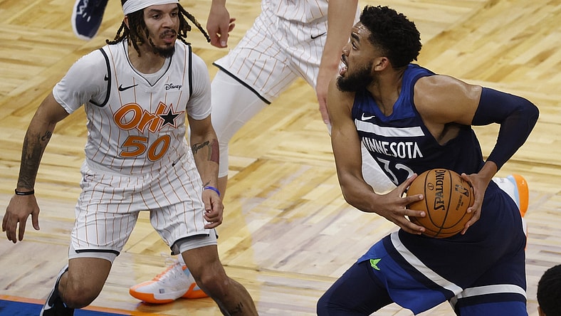 May 9, 2021; Orlando, Florida, USA; Minnesota Timberwolves center Karl-Anthony Towns (32) drives to the basket as Orlando Magic guard Cole Anthony (50) defends during the second half at Amway Center. Mandatory Credit: Kim Klement-USA TODAY Sports