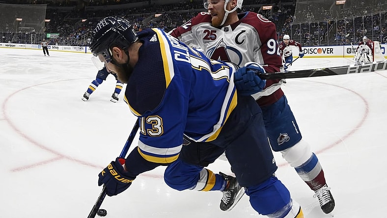 May 21, 2021; St. Louis, Missouri, USA; Colorado Avalanche left wing Gabriel Landeskog (92) checks St. Louis Blues left wing Kyle Clifford (13)in game three of the first round of the 2021 Stanley Cup Playoffs at Enterprise Center. Mandatory Credit: Jeff Le-USA TODAY Sports