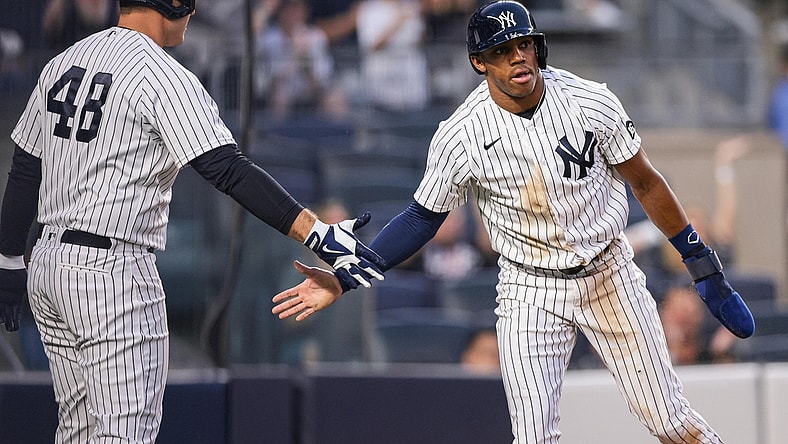Aug 3, 2021; Bronx, New York, USA; New York Yankees left fielder Greg Allen (22) slaps hands with first baseman Anthony Rizzo (48) after scoring a run during the third inning against the Baltimore Orioles at Yankee Stadium. Mandatory Credit: Vincent Carchietta-USA TODAY Sports