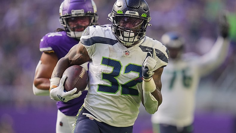 Sep 26, 2021; Minneapolis, Minnesota, USA; Seattle Seahawks running back Chris Carson (32) scores a touchdown against the Minnesota Vikings in the second quarter at U.S. Bank Stadium. Mandatory Credit: Brad Rempel-USA TODAY Sports