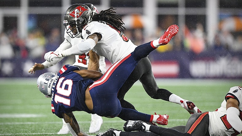 Oct 3, 2021; Foxboro, MA, USA; New England Patriots wide receiver Jakobi Meyers (16) is hit by Tampa Bay Buccaneers cornerback Richard Sherman (5) during the second quarter at Gillette Stadium.  Mandatory Credit: Brian Fluharty-USA TODAY Sports