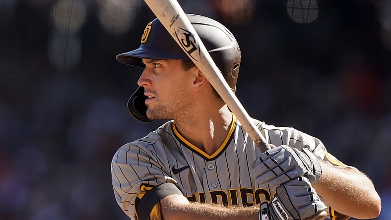 Oct 2, 2021; San Francisco, California, USA; San Diego Padres pinch hitter Adam Frazier (12) bats during the sixth inning against the San Francisco Giants at Oracle Park. Mandatory Credit: Darren Yamashita-USA TODAY Sports