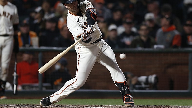 Oct 9, 2021; San Francisco, California, USA; San Francisco Giants catcher Buster Posey (28) hits a double against the Los Angeles Dodgers in the fourth inning during game two of the 2021 NLDS at Oracle Park. Mandatory Credit: D. Ross Cameron-USA TODAY Sports
