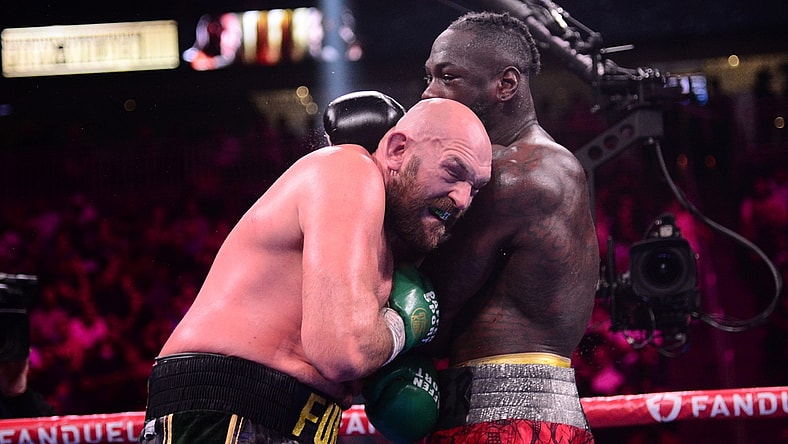 Oct 9, 2021; Las Vegas, Nevada, USA; Deontay Wilder (red/black trunks) and Tyson Fury (black/gold trunks) box during their WBC/Lineal heavyweight championship boxing match at T-Mobile Arena. Mandatory Credit: Joe Camporeale-USA TODAY Sports