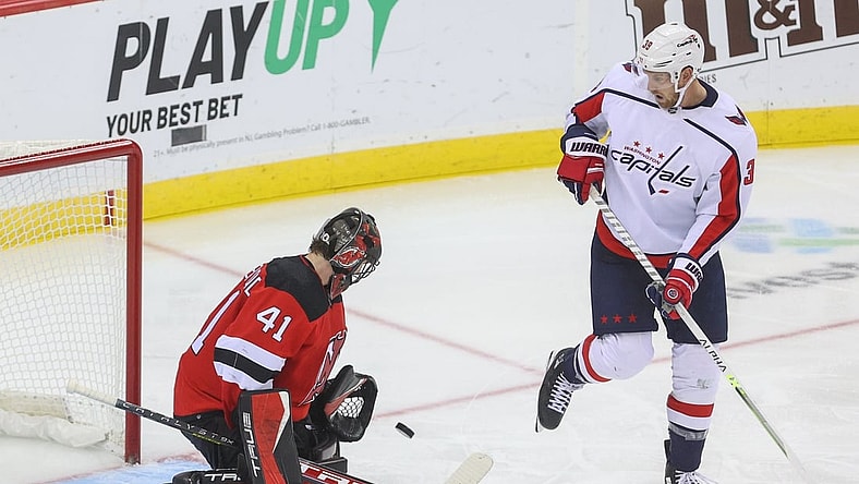 Oct 21, 2021; Newark, New Jersey, USA; New Jersey Devils goaltender Scott Wedgewood (41) makes a save on Washington Capitals right wing Anthony Mantha (39) during the third period at Prudential Center. Mandatory Credit: Ed Mulholland-USA TODAY Sports