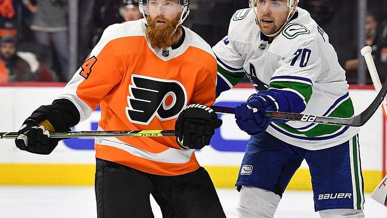 Oct 15, 2021; Philadelphia, Pennsylvania, USA; Philadelphia Flyers defenseman Ryan Ellis (94) and Vancouver Canucks left wing Tanner Pearson (70) battle at Wells Fargo Center. Mandatory Credit: Eric Hartline-USA TODAY Sports