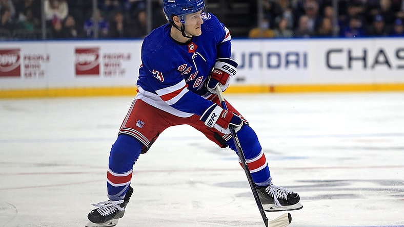 Oct 25, 2021; New York, New York, USA; New York Rangers defenseman Adam Fox (23) controls the puck against the Calgary Flames during the second period at Madison Square Garden. Mandatory Credit: Danny Wild-USA TODAY Sports