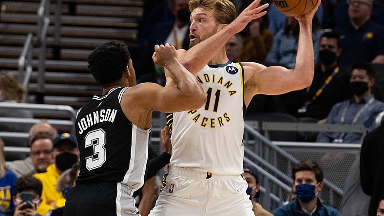 Nov 1, 2021; Indianapolis, Indiana, USA; Indiana Pacers forward Domantas Sabonis (11) controls the ball while San Antonio Spurs forward Keldon Johnson (3) defends  in the first quarter at Gainbridge Fieldhouse. Mandatory Credit: Trevor Ruszkowski-USA TODAY Sports
