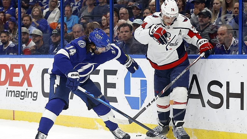 Nov 1, 2021; Tampa, Florida, USA;Tampa Bay Lightning left wing Pat Maroon (14) and Washington Capitals defenseman John Carlson (74) skates with the puck during the first quarter at Amalie Arena. Mandatory Credit: Kim Klement-USA TODAY Sports