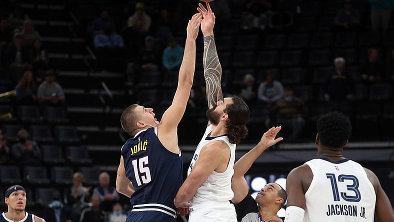 Nov 1, 2021; Memphis, Tennessee, USA; Denver Nuggets center Nikola Jokic (15) and Memphis Grizzles center Steven Adams (4) jump ball to start the game at FedExForum. Mandatory Credit: Petre Thomas-USA TODAY Sports