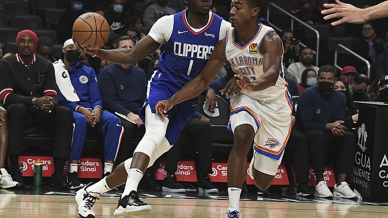Nov 1, 2021; Los Angeles, California, USA;  LA Clippers guard Reggie Jackson (1) looks to pass the ball defended by Oklahoma City Thunder guard Theo Maledon (11) during the first half at Staples Center. Mandatory Credit: Richard Mackson-USA TODAY Sports