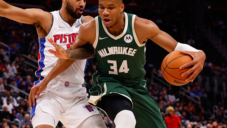 Nov 2, 2021; Detroit, Michigan, USA; Milwaukee Bucks forward Giannis Antetokounmpo (34) is defended by Detroit Pistons forward Trey Lyles (8) in the first half at Little Caesars Arena. Mandatory Credit: Rick Osentoski-USA TODAY Sports