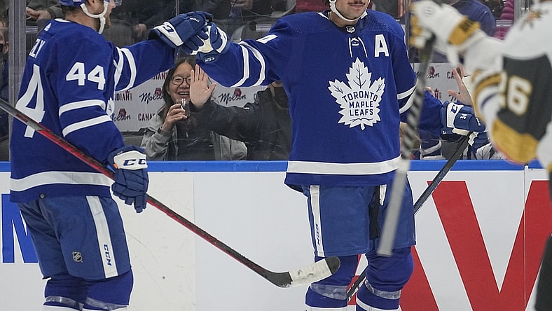 Nov 2, 2021; Toronto, Ontario, CAN; Toronto Maple Leafs defenseman Morgan Rielly (44) congratulates Toronto Maple Leafs forward Auston Matthews (34) on his first goal against the Vegas Golden Knights during the second period at Scotiabank Arena. Mandatory Credit: John E. Sokolowski-USA TODAY Sports