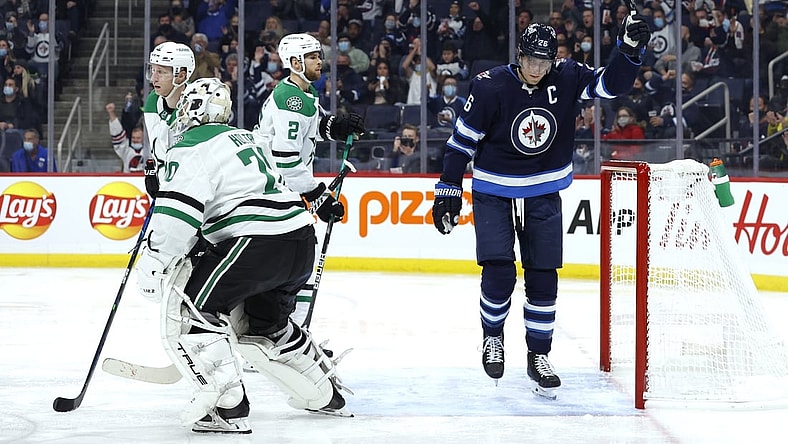 Nov 2, 2021; Winnipeg, Manitoba, CAN; Winnipeg Jets right wing Blake Wheeler (26) celebrates the second period goal by Winnipeg Jets defenseman Josh Morrissey (44) on Dallas Stars goaltender Braden Holtby (70) at Canada Life Centre. Mandatory Credit: James Carey Lauder-USA TODAY Sports