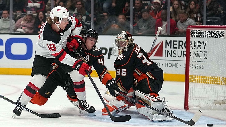 Nov 2, 2021; Anaheim, California, USA; Anaheim Ducks defenseman Cam Fowler (4) and goaltender John Gibson (36) defend the goal against New Jersey Devils center Dawson Mercer (18)  in the first period at Honda Center. Mandatory Credit: Kirby Lee-USA TODAY Sports
