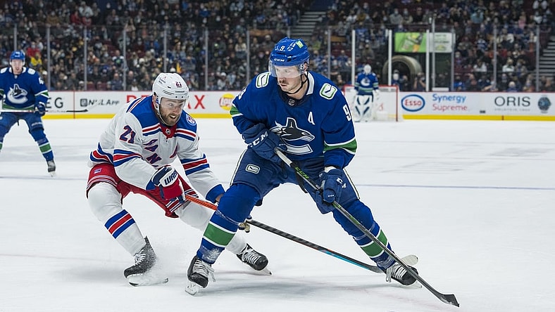 Nov 2, 2021; Vancouver, British Columbia, CAN; New York Rangers  forward Barclay Goodrow (21) checks Vancouver Canucks forward J.T. Miller (9) in the first period at Rogers Arena. Mandatory Credit: Bob Frid-USA TODAY Sports