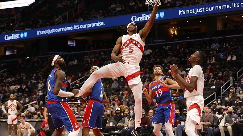 Nov 3, 2021; Washington, District of Columbia, USA; Toronto Raptors forward Precious Achiuwa (5) shoots the ball as Washington Wizards center Montrezl Harrell (6) looks on during the first quarter at Capital One Arena. Mandatory Credit: Geoff Burke-USA TODAY Sports