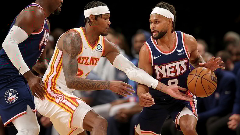 Nov 3, 2021; Brooklyn, New York, USA; Atlanta Hawks forward Cam Reddish (22) reaches for a ball controlled by Brooklyn Nets guard Patty Mills (8) in front of Nets forward Paul Millsap (31) during the second quarter at Barclays Center. Mandatory Credit: Brad Penner-USA TODAY Sports