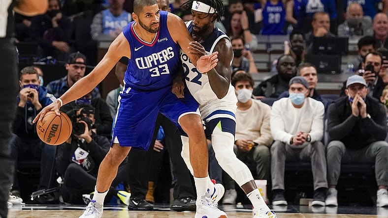 Nov 3, 2021; Minneapolis, Minnesota, USA;  Los Angeles Clippers forward Nicolas Batum (33) protects the ball from Minnesota Timberwolves guard Patrick Beverly (22) during the first quarter at Target Center. Mandatory Credit: Nick Wosika-USA TODAY Sports