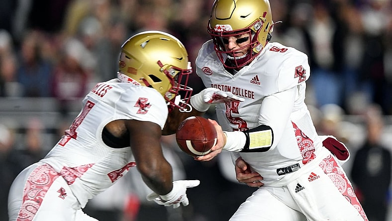 Nov 5, 2021; Chestnut Hill, Massachusetts, USA; Boston College Eagles quarterback Phil Jurkovec (5) hands the ball off to running back Pat Garwo III (24) during the first half at Alumni Stadium. Mandatory Credit: Brian Fluharty-USA TODAY Sports