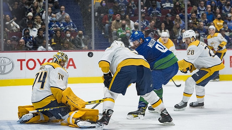 Nov 5, 2021; Vancouver, British Columbia, CAN; Nashville Predators goalie Juuse Saros (74) makes a save on Vancouver Canucks forward J.T. Miller (9) in the first period at Rogers Arena. Mandatory Credit: Bob Frid-USA TODAY Sports