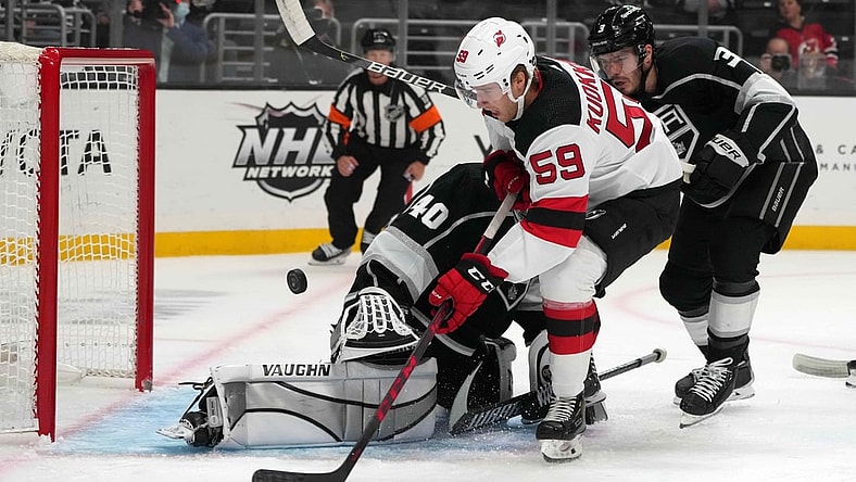 Nov 5, 2021; Los Angeles, California, USA; New Jersey Devils center Janne Kuokkanen (59) takes a shot against LA Kings goaltender Cal Petersen (40)  in the first period at Staples Center. Mandatory Credit: Kirby Lee-USA TODAY Sports